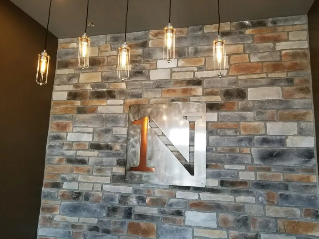 Metal numeral on brick feature wall
