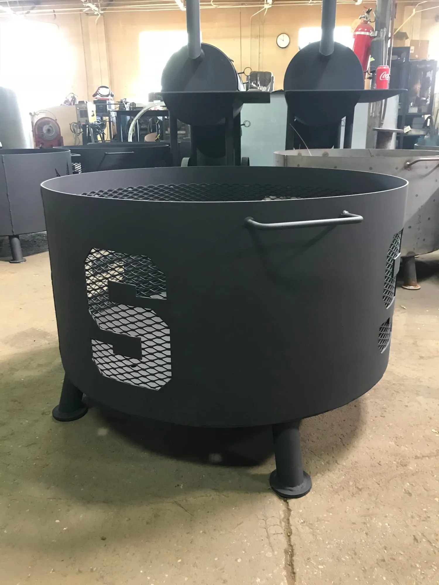 Steel fire pit with cut-out lettering